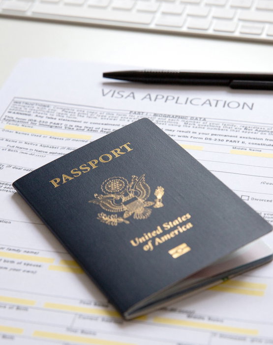 American,Passport,With,Visa,Application,Documents,,Black,Pan,And,Computer A passport and a visa application